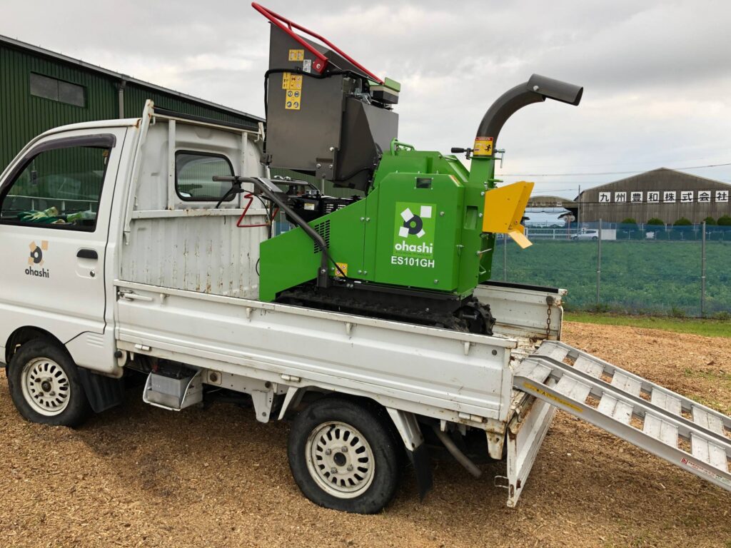 photo of Ohashi ES101GH 4-inch compact tracked woodchipper Loaded onto an ohashi branded small truck 
