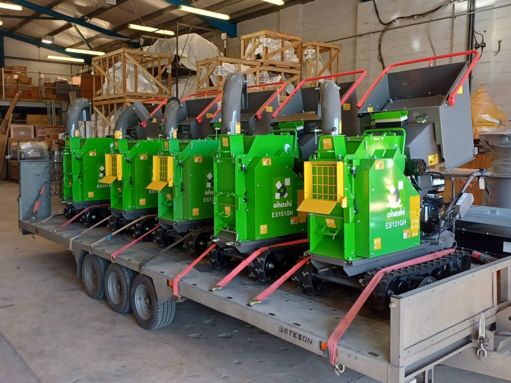 Photo of 5 Ohashi ES131GH 5-inch Compact tracked woodchippers loaded onto a trailer in a warehouse
