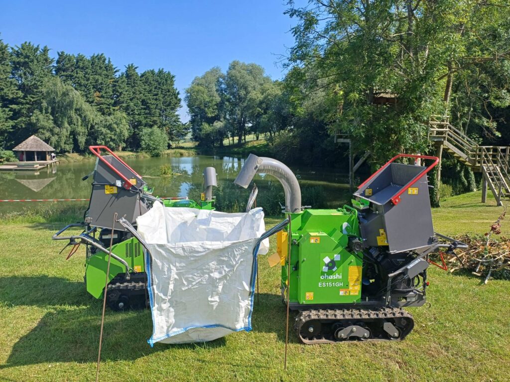Photo of an ohashi ES151GH outside by a small lake chipping wood into a large bag in the sun