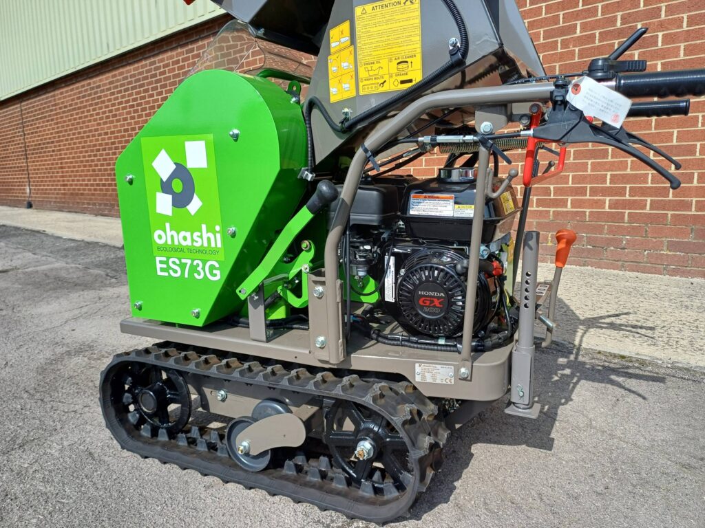 Photo of the engine of the Ohashi ES73G Compact tracked Woodchipper with brick wall background

