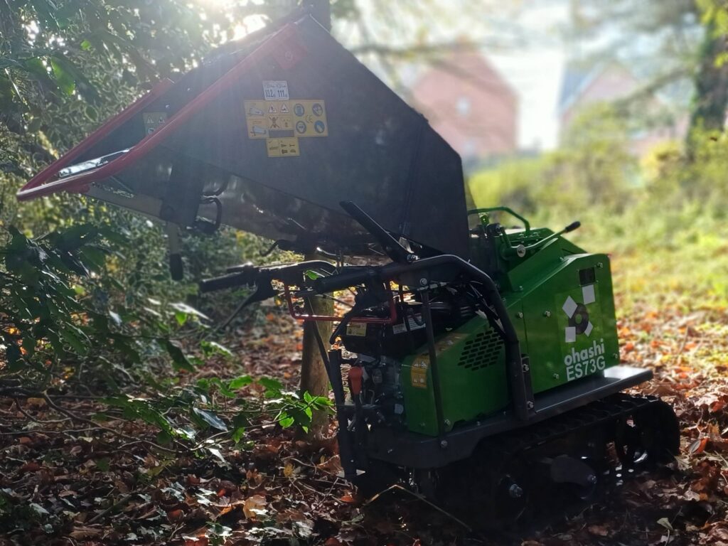 Photo of Ohashi ES73G Compact tracked woodchipper in the woods with a sunny background
